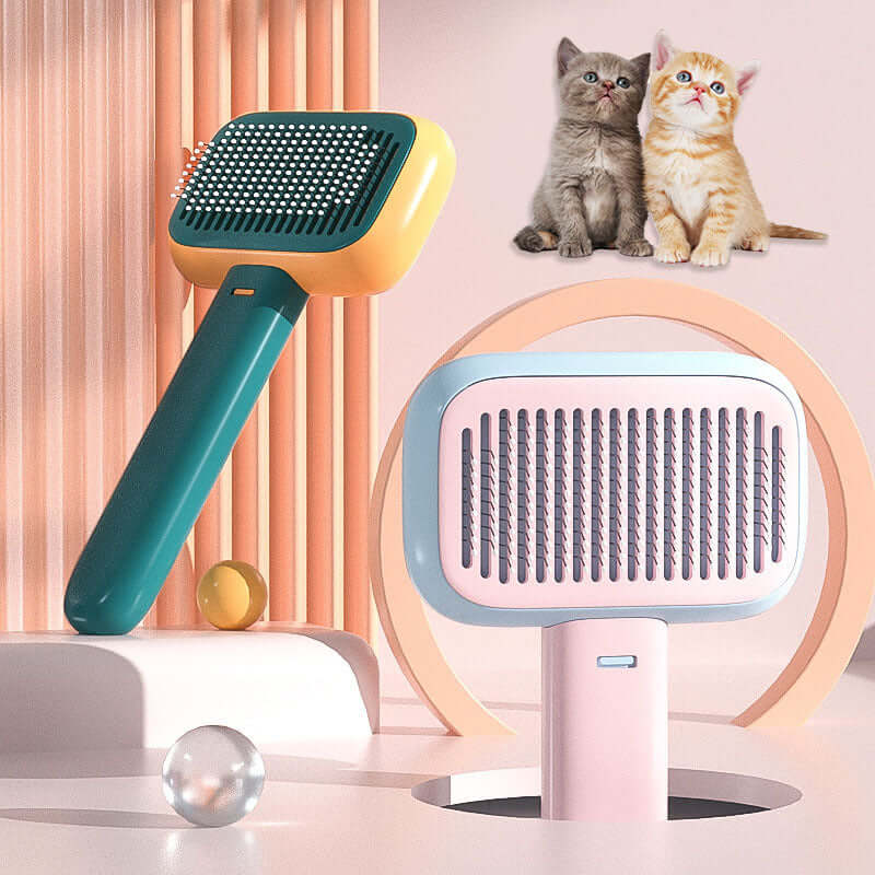 Open-knot grooming brush in smoke grey and pastel colors with playful kittens in the background.