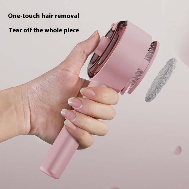Hand holding a pink one-touch hair removal brush designed for easy pet hair cleaning and maintenance.