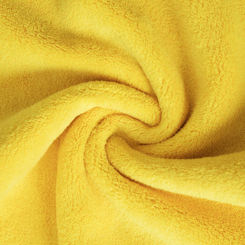 Close-up of a soft, yellow quick-drying towel fabric, ideal for drying pets after baths.